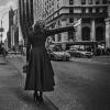 Woman hailing cab, black and white photo
