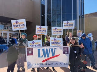 League members with banner at March 2026 No Kings Rally