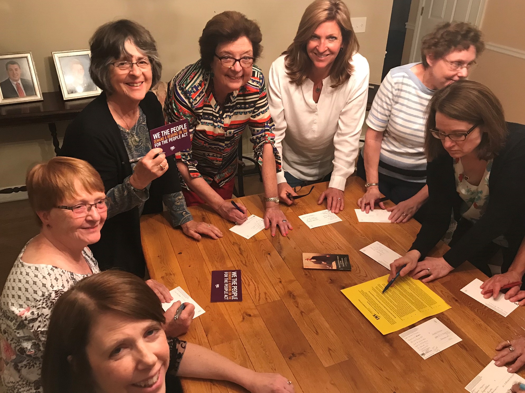 Board Meeting Members standing around a table
