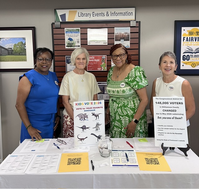 Photo of four women behind a table at the Franklin Library