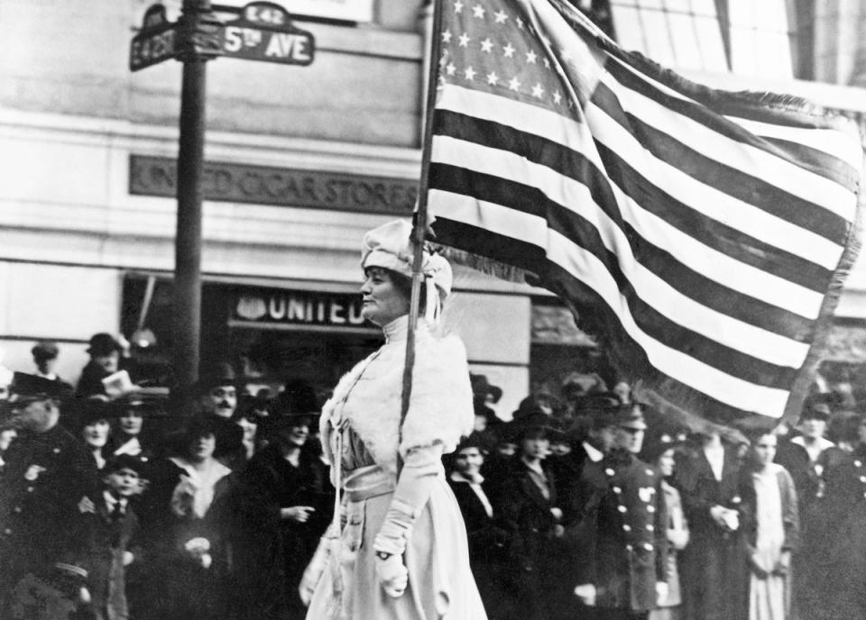 sufferagist marching w flag